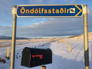 a street sign on a snow covered field at Öndólfsstaðir Farm B&B in Laugar