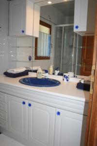 a bathroom with a blue sink and a mirror at Mas des Petits Loups in Cabrières +80 photos
