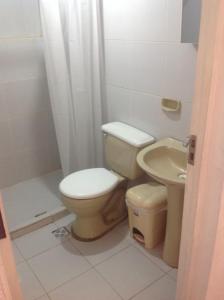 a bathroom with a toilet and a sink at San Antonio de Tupuraya in Cochabamba