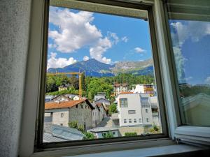 a view of a city from a window at Sankt-Nikolaus Studio Innsbruck in Innsbruck