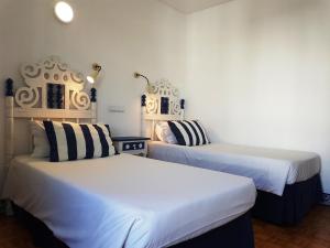 Ліжко або ліжка в номері Apartamentos Turisticos Soldoiro