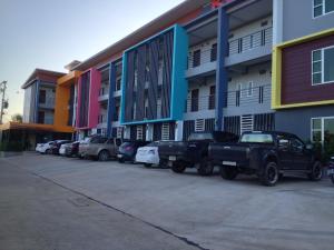 a row of cars parked in front of a building at K2 Living Hotel in Uttaradit