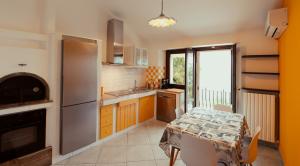 a kitchen with a table and a dining room at Casa Teresa Relais in Sirolo