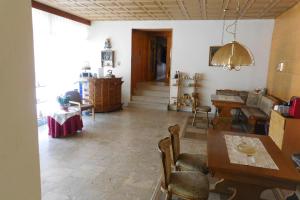 a living room with a table and a dining room at Hotel Pension am Kurmittelhaus in Bad Grund