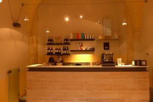 a bar in a restaurant with a counter with alcohol bottles at Landolina Palace Hotel in Noto