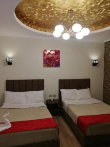 a bedroom with two beds and a ceiling at Cordoba Suites in Hurghada
