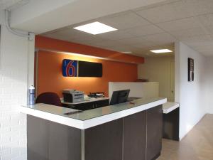 an office with a desk with a computer and a monitor at Motel 6 Baltimore MD in Baltimore