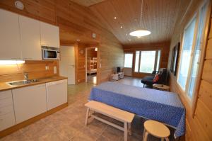 a kitchen and living room with a table in a cabin at Apartment A3 Talja in Rovaniemi