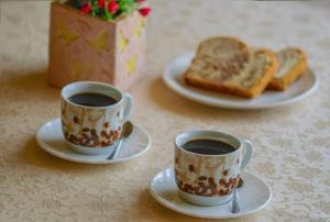 two cups of coffee and two plates of toast at Star Beach Resort in Makrygialos