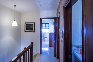 a hallway with a glass door leading to a bathroom at Rooms in El Medano in El Médano
