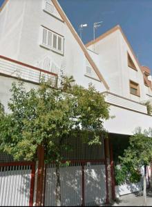 a white building with a fence in front of it at I 13 Cavalieri Guest House in Barletta