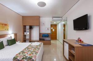 a hotel room with a bed and a flat screen tv at Blue Tree Premium Manaus in Manaus