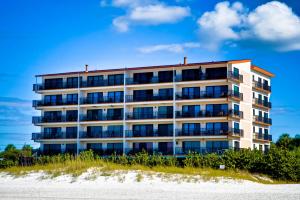 a building on the beach next to the sand at Surfside Condos 202 in Clearwater Beach
