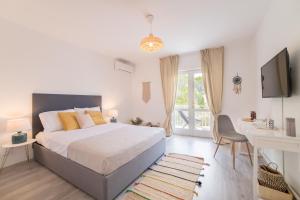 a bedroom with a bed and a desk and a television at Villa Astra in Brela