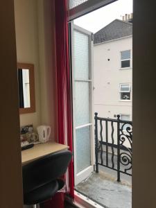 a window with a view of a balcony at Cassandra Guest House in Plymouth