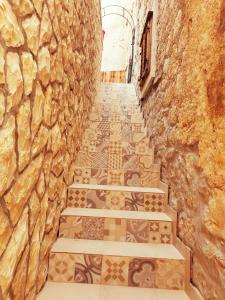 an alley with stone walls and stone stairs at Villa Eximia Novigrad in Novigrad Dalmatia