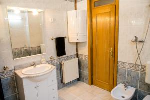 a bathroom with a sink and a toilet and a mirror at Studio 35 Busteni in Buşteni