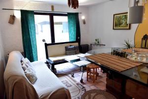 a living room with a couch and a table at Leśna Strzecha Domek in Rotembark