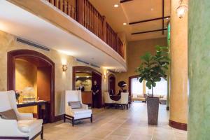 a lobby with a salon with white chairs and a table at The Mutiny Luxury Suites Hotel in Miami