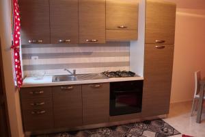 a kitchen with a sink and a stove top oven at casa vacanza EVERY DAY in SantʼAngelo le Fratte