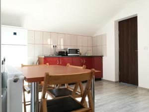 a kitchen with a table and chairs in a room at Casa Jolie in Constanţa