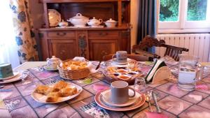 a table with pastries and cups on top of it at villatiffany in Torriglia