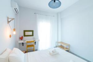 依拉佩特拉的住宿－Rodamos apartment，白色卧室配有床和书桌