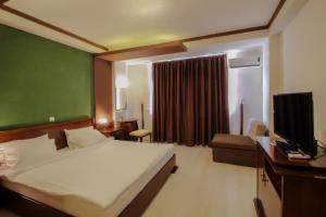 Voodi või voodid majutusasutuse Hotel Aleksandrija toas