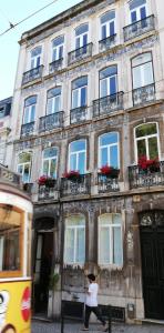 a person walking in front of a building at Lisbon Dreams Estrela Suites in Lisbon