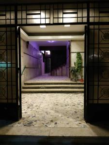 an open door of a building with stairs and a hallway at Al Marwa Apartment in Dokki - Families Only in Cairo