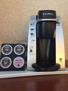 a coffee maker and a box on a shelf at Hotel Pentagon in Arlington