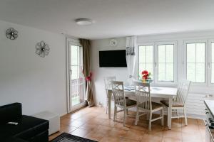 グリンデルワルトにあるAmazing Apartment EIGER Grindelwaldのダイニングルーム(白いテーブル、椅子付)