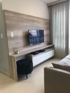 a living room with a flat screen tv on a wall at Apto Promenade I PONTA VERDE in Maceió