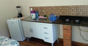 a small kitchen with a sink and a counter at Flats Pedra Riscada in Lumiar