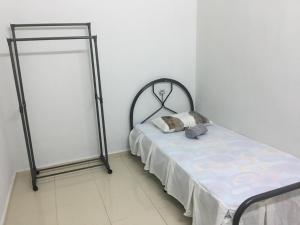 a bed in a room with a bed frame at Taman Rambai Utama Homestay in Malacca
