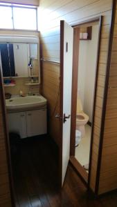 a bathroom with a sink and a toilet at Nobu Guest House in Kanayama