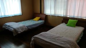 Postel nebo postele na pokoji v ubytování Nobu Guest House