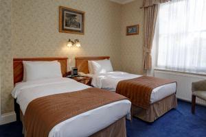Ein Bett oder Betten in einem Zimmer der Unterkunft Best Western Swiss Cottage Hotel