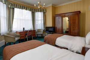 Ein Bett oder Betten in einem Zimmer der Unterkunft Best Western Swiss Cottage Hotel