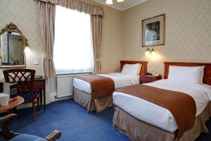 Ein Bett oder Betten in einem Zimmer der Unterkunft Best Western Swiss Cottage Hotel