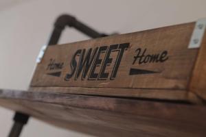 a wooden bench with the words sweet home written on it at Best Western White House Hotel in Watford