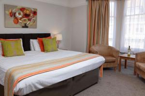 a hotel room with a large bed and a chair at Best Western Brook Hotel in Felixstowe