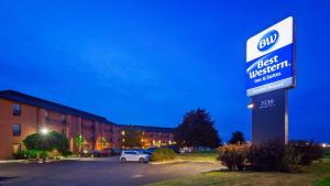 a sign for a best western hotel in a parking lot at Best Western London Airport Inn & Suites in London