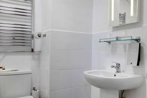 a bathroom with a sink, toilet and mirror at Best Western Andover in Andover