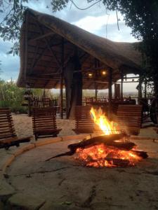 a fire pit in front of a pavilion at Caprivi Houseboat Safari Lodge in Katima Mulilo