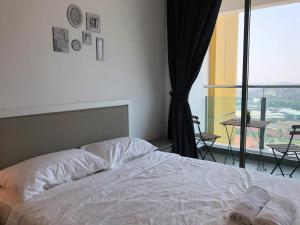 a bedroom with a bed and a large window at Heart of Bandar Baru Bangi (2) in Bangi