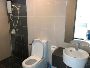 a bathroom with a toilet and a sink at Heart of Bandar Baru Bangi (2) in Bangi