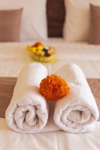 a couple of towels sitting on top of a bed at Umah Nugraha in Canggu