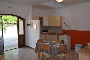 a kitchen with a table with chairs and a tablecloth on it at IL TURRIONE "app. Santa Chiara" in Assisi