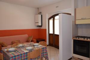 a living room with a table and a kitchen at IL TURRIONE "app. Santa Chiara" in Assisi